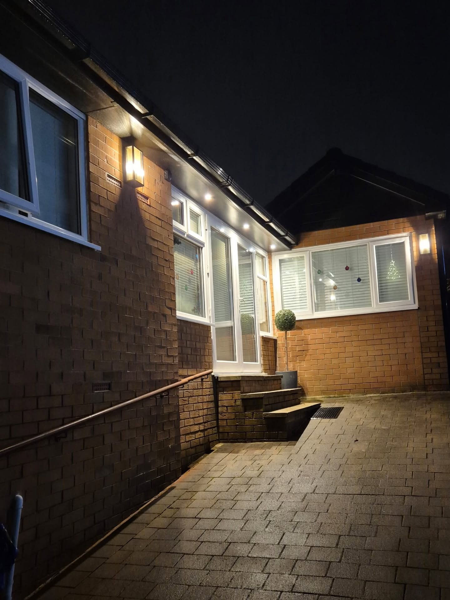 Family home at night showing the finished roof, fascias, soffits and guttering